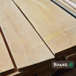 Close-up of smooth, light-colored extra grade edged alder boards.