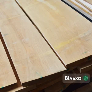 Close-up of smooth, light-colored extra grade edged alder boards.