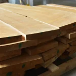 Ends and side edges of edged alder lumber boards stacked together.