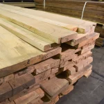 Angled view of premium edged ash boards stacked on a pallet.