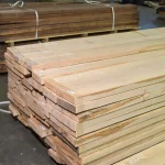 High-angle view of a large stack of dry edged ash boards ready for processing.