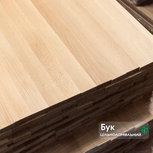 Close-up of a stack of solid-lamella beech edge-glued panels showing the smooth wood grain.