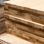 Side view of stacked beech panels showing the precise solid-lamella edge gluing.