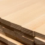 Close-up of the clean cut ends of stacked 20mm beech furniture panels.