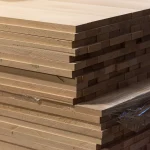 Corner view of a neat stack of Grade 1 solid beech panels ready for shipping.