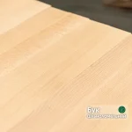 Close-up texture of a solid-lamella beech furniture panel showing the natural wood grain.