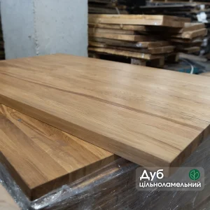 Solid oak furniture panel with a watermark highlighting the premium solid-lamella structure.