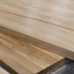 Two overlapping solid oak panels highlighting the precise edge cutting and thickness.