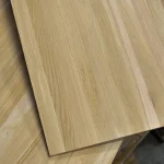 Close-up of overlapping oak panels showing precise edge gluing and high-quality surface finish.