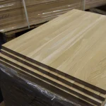 Stack of finished solid-lamella oak panels on a warehouse pallet.