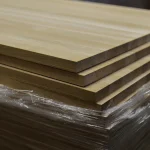 Close-up of the corners and edges of stacked oak edge-glued boards.