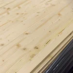 Smoothly sanded surface of a solid-lamella pine board shown at an angle with natural wood texture.