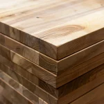 Close-up of the corner and end grain of stacked 40mm solid ash furniture panels.