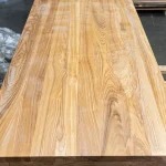 Direct top view of a solid-laminated ash furniture panel showcasing continuous wood lamellas.