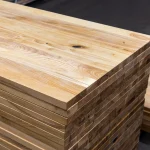 Perspective view of stacked rustic grade ash panels highlighting natural wood characteristics.