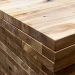 Detailed close-up of the edge-glued lamella joints on the end of the ash furniture panel.