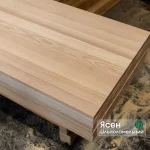 Stack of solid-lamella ash edge-glued panels showing the smooth surface and natural wood grain.