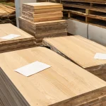 Angled view of ash furniture panels showing the beautiful natural wood grain texture.