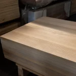Angled view of the top surface of a premium ash edge-glued panel stack.