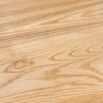 Detailed view of the natural wavy wood grain pattern on a rustic grade ash furniture panel.