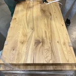 Top-down view of a 1.75x0.9m solid ash furniture panel showing its rustic texture.