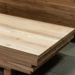Side perspective of stacked ash panels highlighting the precise 40mm thickness and clean edges.