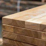 Close-up of the end grain and seamless glue joints of solid-lamella ash boards.