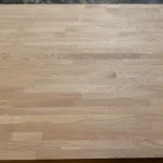 Top-down view of the finger-jointed oak furniture board texture showing the block pattern.