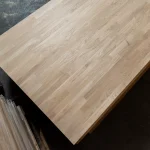 High angle view of the corner of a finger-jointed oak furniture board.