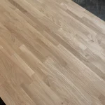 Diagonal close-up of the finger-jointed oak wood grain and joints.