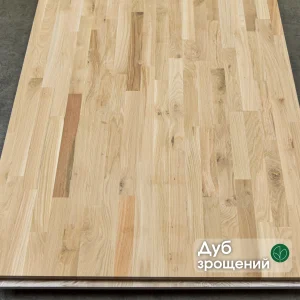 Close-up of the surface of a finger-jointed oak furniture panel showing the wood grain and joints.