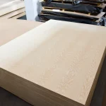 Stack of 39 mm white ash veneered blockboards stored in a warehouse.