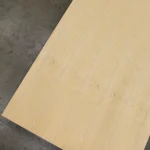 Full sheet of 2100x900 mm blockboard veneered with white ash on a concrete floor.