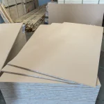 Stack of HDF-faced blockboards in a warehouse with several sheets slightly shifted.