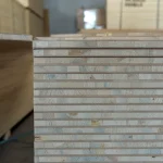 Side view of a stack of blockboards showing the layered structure of the solid wood core.