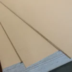 Close-up of the smooth surface of overlapping HDF-faced blockboard sheets.