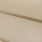 Detailed view of the thin edge and uniform surface texture of HDF-faced blockboard.