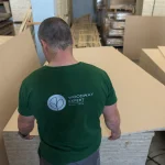 Woodway Expert worker inspecting a stack of HDF-faced blockboard panels in the warehouse.