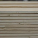 Close-up of the 13 mm blockboard edge, showing the solid wood core strips between HDF faces.