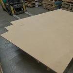 Large sheet of HDF-faced blockboard 2800x2070 mm on a pallet in a workshop.