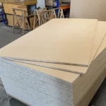 Large stack of 2500x1250 mm HDF-faced blockboards ready for shipping or processing.