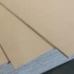 Top-down view of the smooth, light-brown HDF surface of the blockboard.