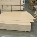 Large 2800x2070 mm HDF-faced blockboard sheets stacked in a spacious warehouse.