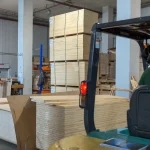 Warehouse storage of HDF-faced blockboards with a forklift in the foreground.