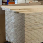 A neat stack of HDF-faced blockboards 38 mm thick stored in a woodworking warehouse.