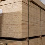 Stack of Ceiba blockboards in a warehouse showing the solid wood core structure.