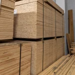 Large warehouse stack of packaged 13mm Ceiba blockboard panels.