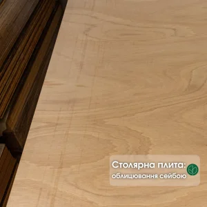 Close-up of the Ceiba veneered blockboard surface showing the light wood grain texture.
