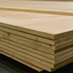 Close-up of the edges of stacked ceiba veneered blockboards highlighting the thickness and core.
