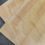 Overlapping ceiba veneered blockboard sheets showcasing the consistent light wood grain.